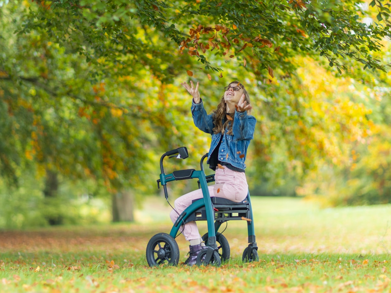 a woman standing next to a child in a stroller